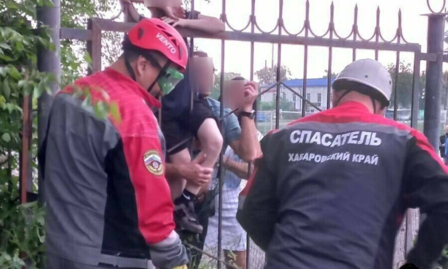 Ребенок перелезал через забор и повис на зубце